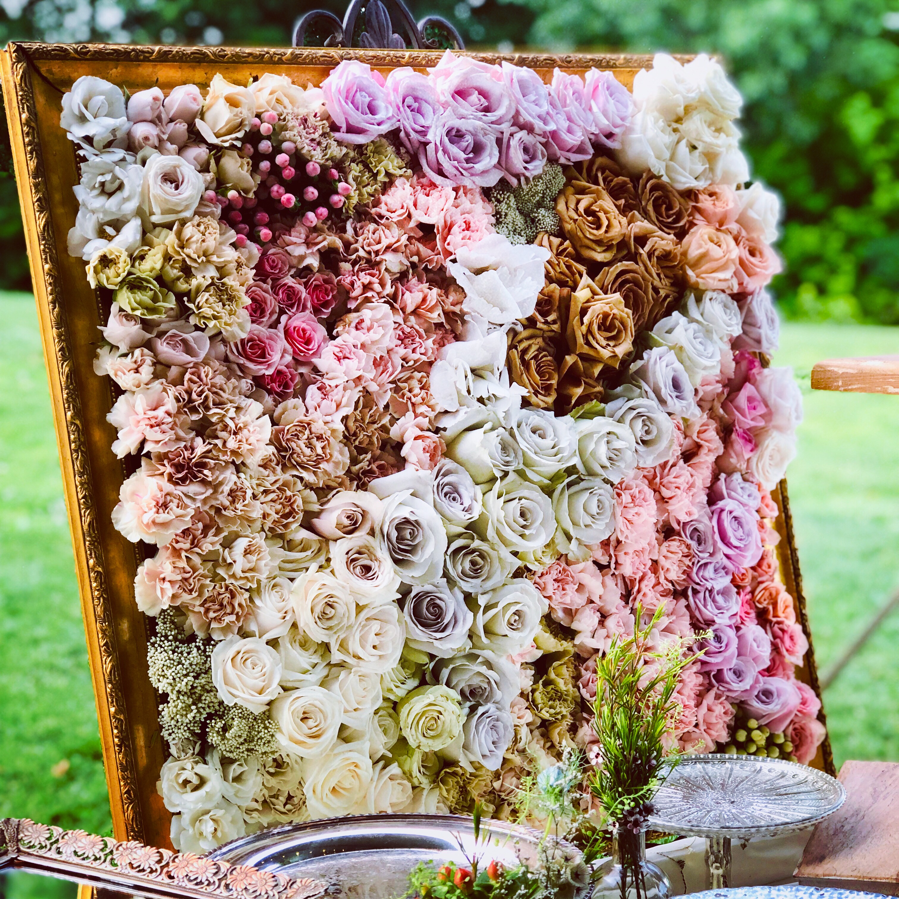 A gilded frame filled with hundreds of roses &mdash; an early floral installation by Elizabeth Fichter