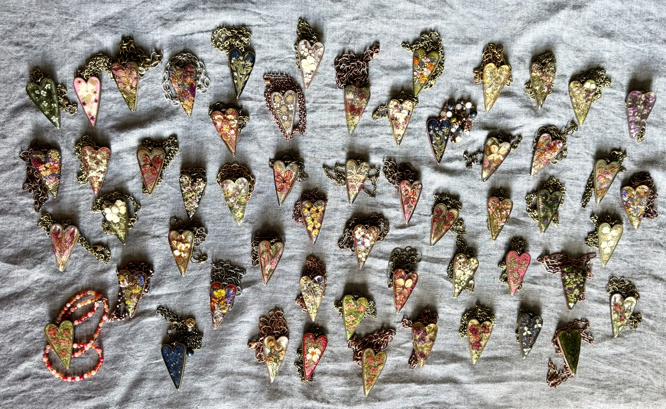 The full Sacred Hearts collection — elongated heart pendants by Floral Alchemy, laid out together