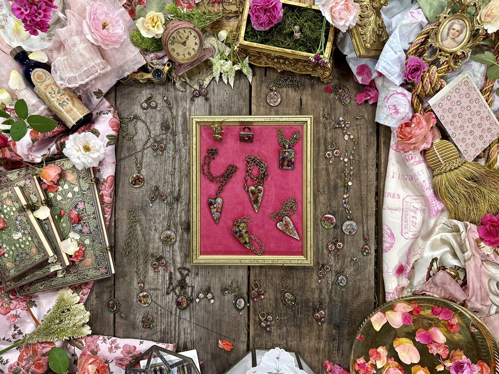 A chain arranged into the shape of a heart on dark botanical fabric — Floral Alchemy Sacred Hearts