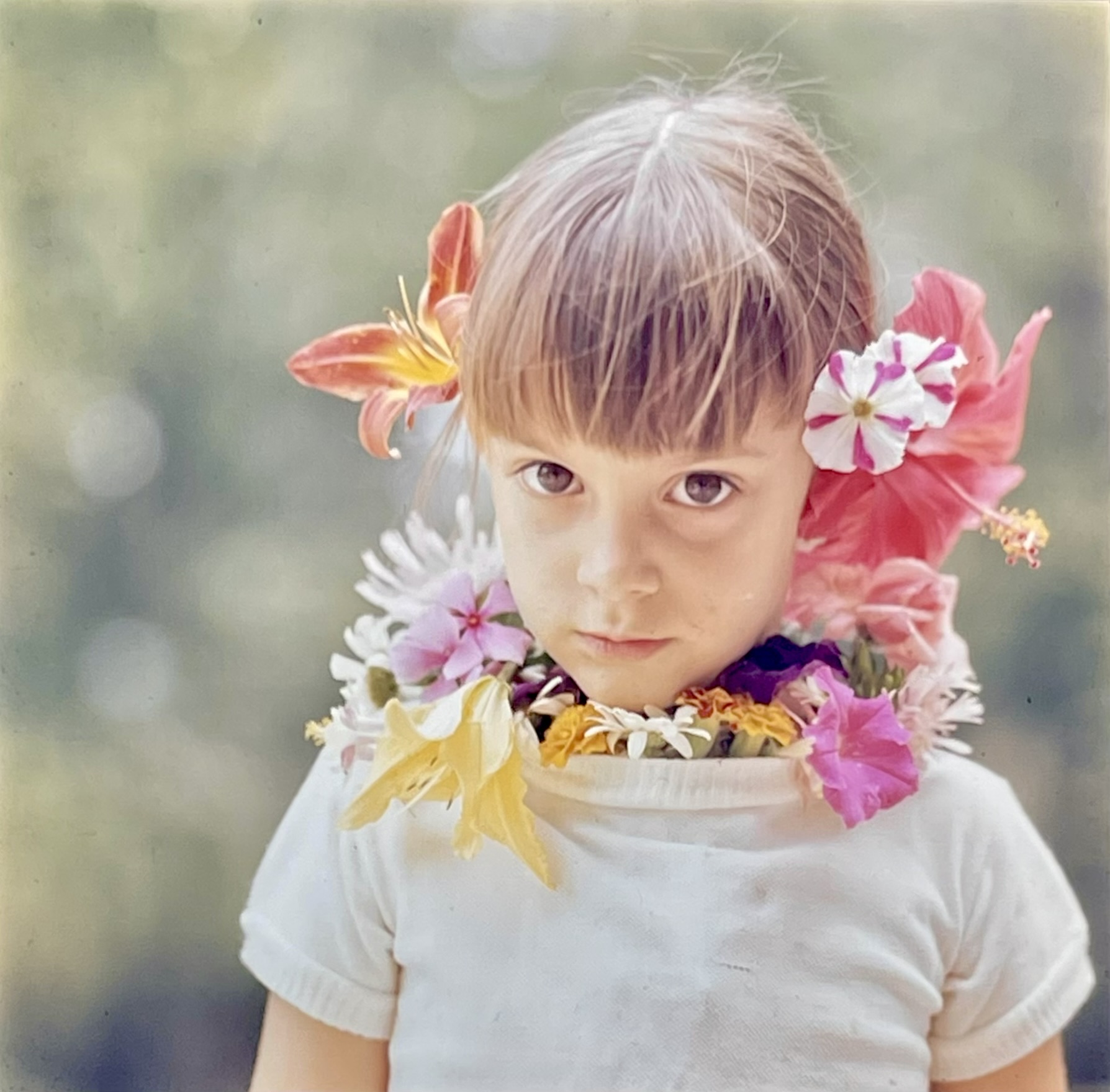Luli as a child, adorned with flowers